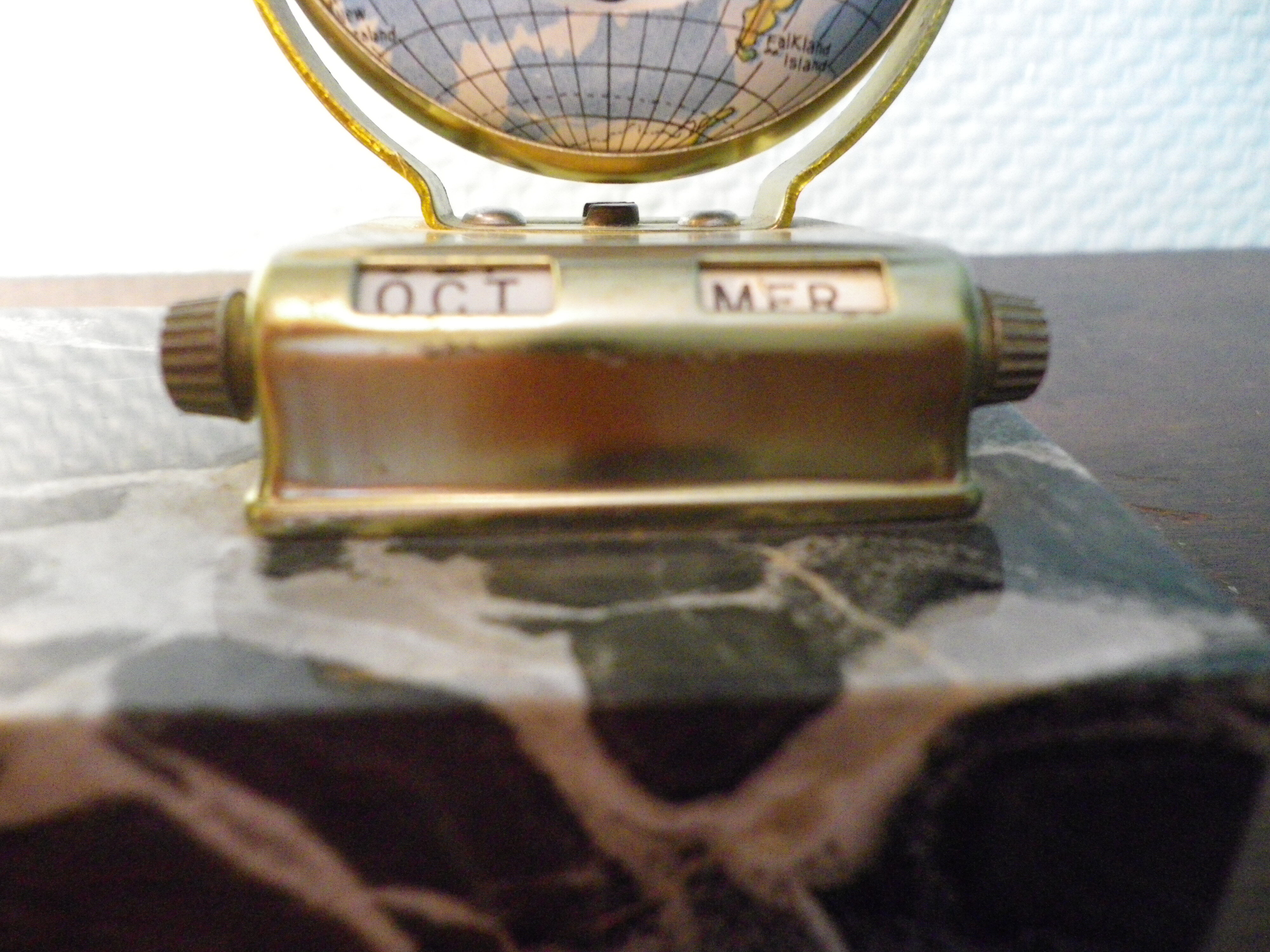 Perpetual calendar on marble base with marble patinated regulated decoration, 60s