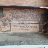 Craft cabinet with drawers with a very old tobacco advertisement in the background