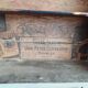 Craft cabinet with drawers with a very old tobacco advertisement in the background