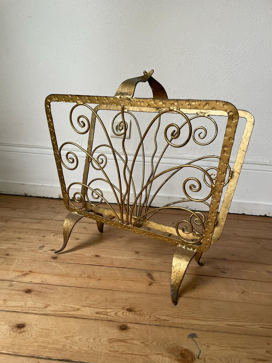 Vintage wrought iron magazine rack with gold butterfly design