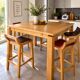 Table haute en bois massif extensible + 4 tabourets