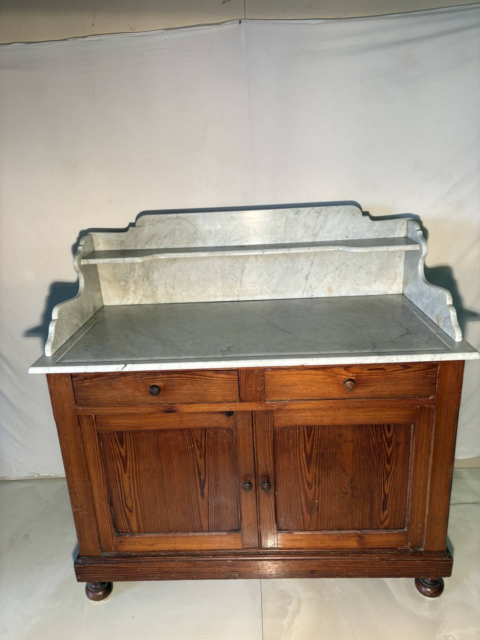 Antique wood and marble kitchen sideboard with carved backsplash