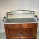 Antique wood and marble kitchen sideboard with carved backsplash