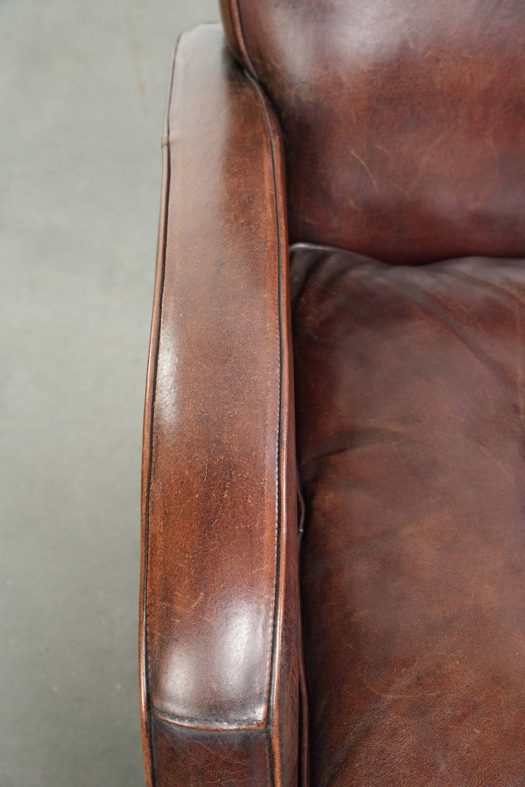 Dark cognac-coloured set of 2 sheepskin armchairs with a sleek design