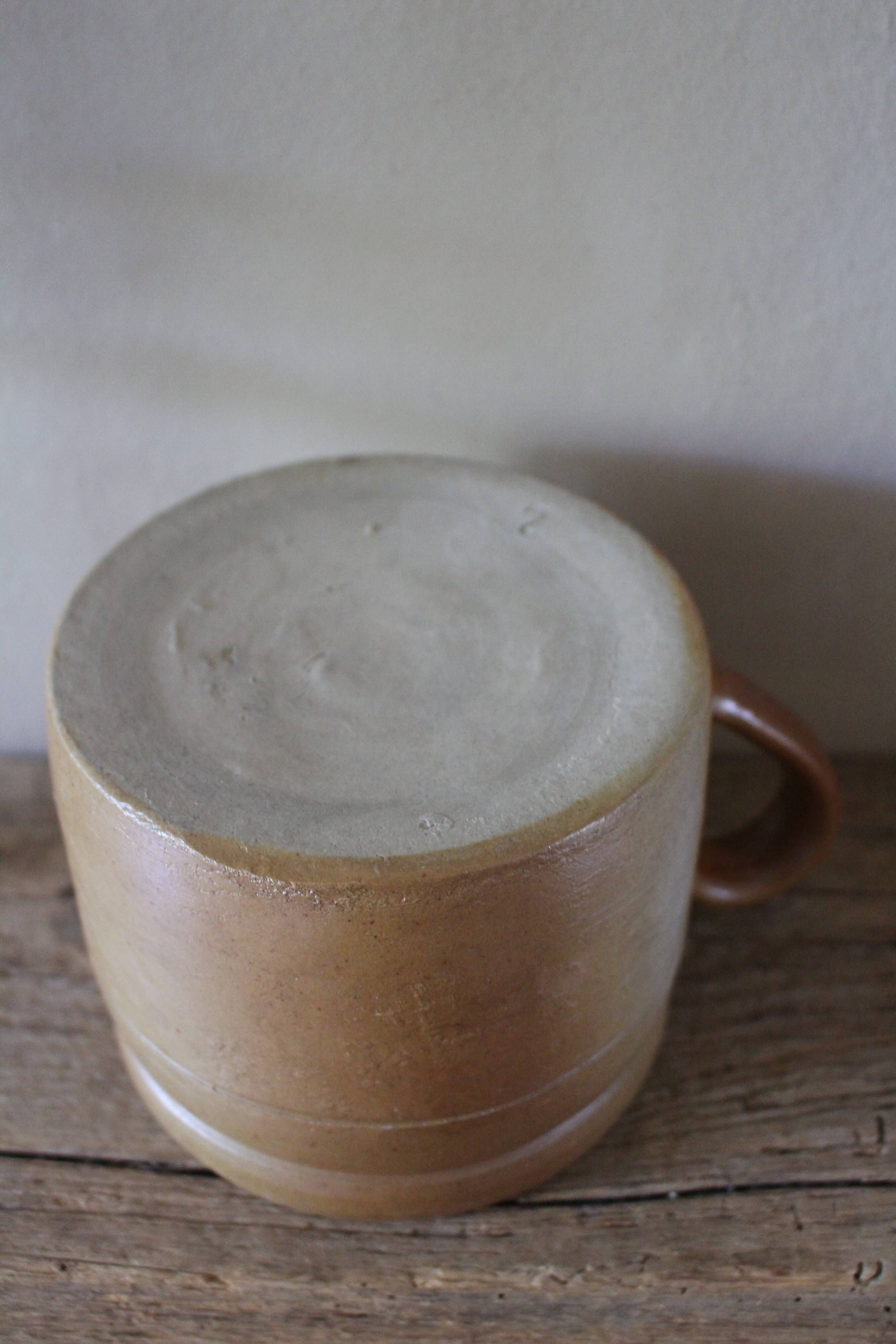 Vase terracotta milk jug with a glazed interior handle.