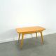 Vintage veneer table with pretty angular legs and brass at the base of the legs.