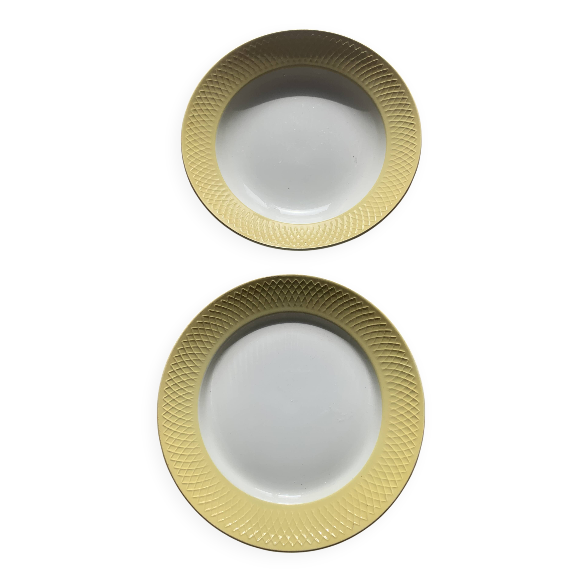 Two earthenware dishes, one hollow and one white cake dish with yellow border