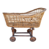 Old rattan cradle on wheels