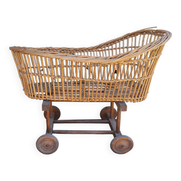 Old rattan cradle on wheels