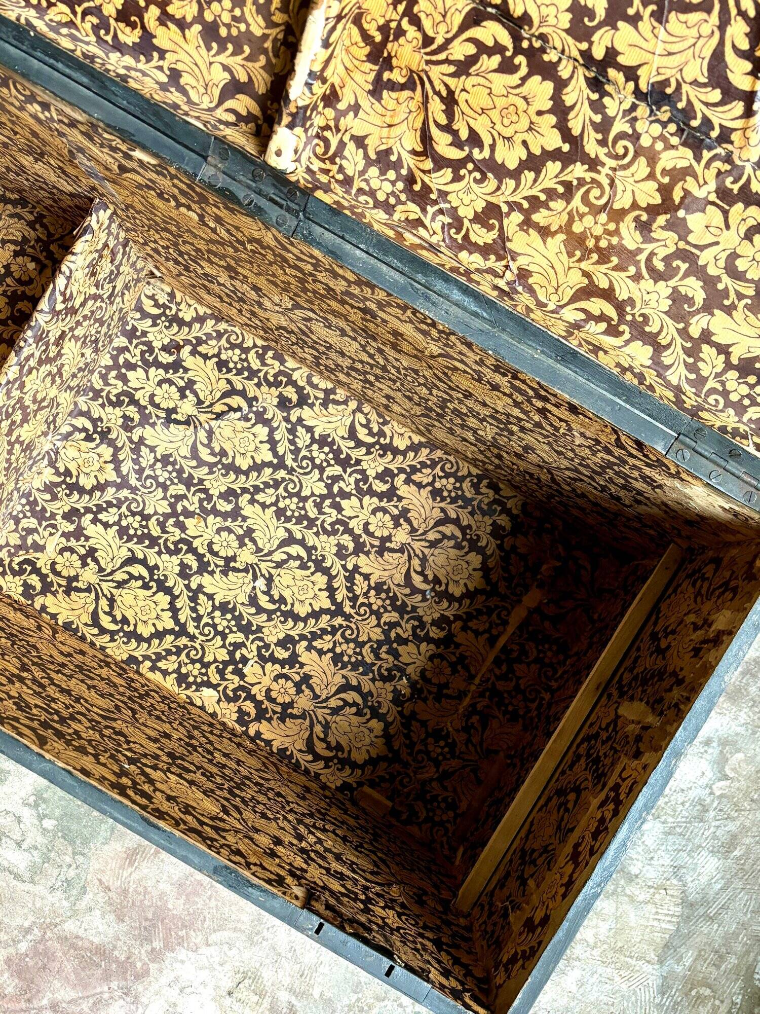 Trunk, black wooden chest and wallpaper