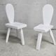 Pair of tripod chairs, gouged seats. Brutalist, circa 1960. Painted wood.