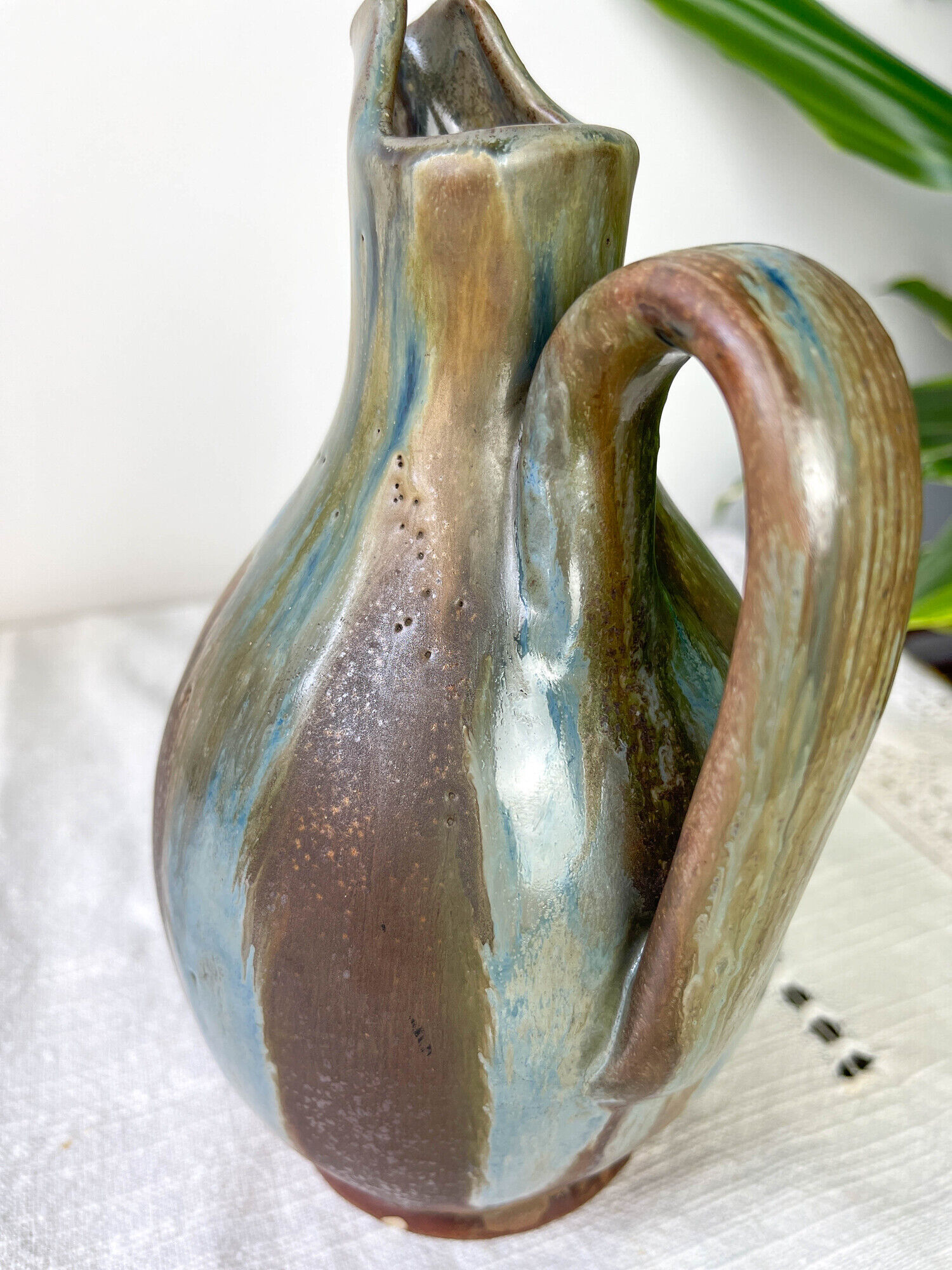 Art Nouveau style carafe in flamed stoneware with blue and brown drips
