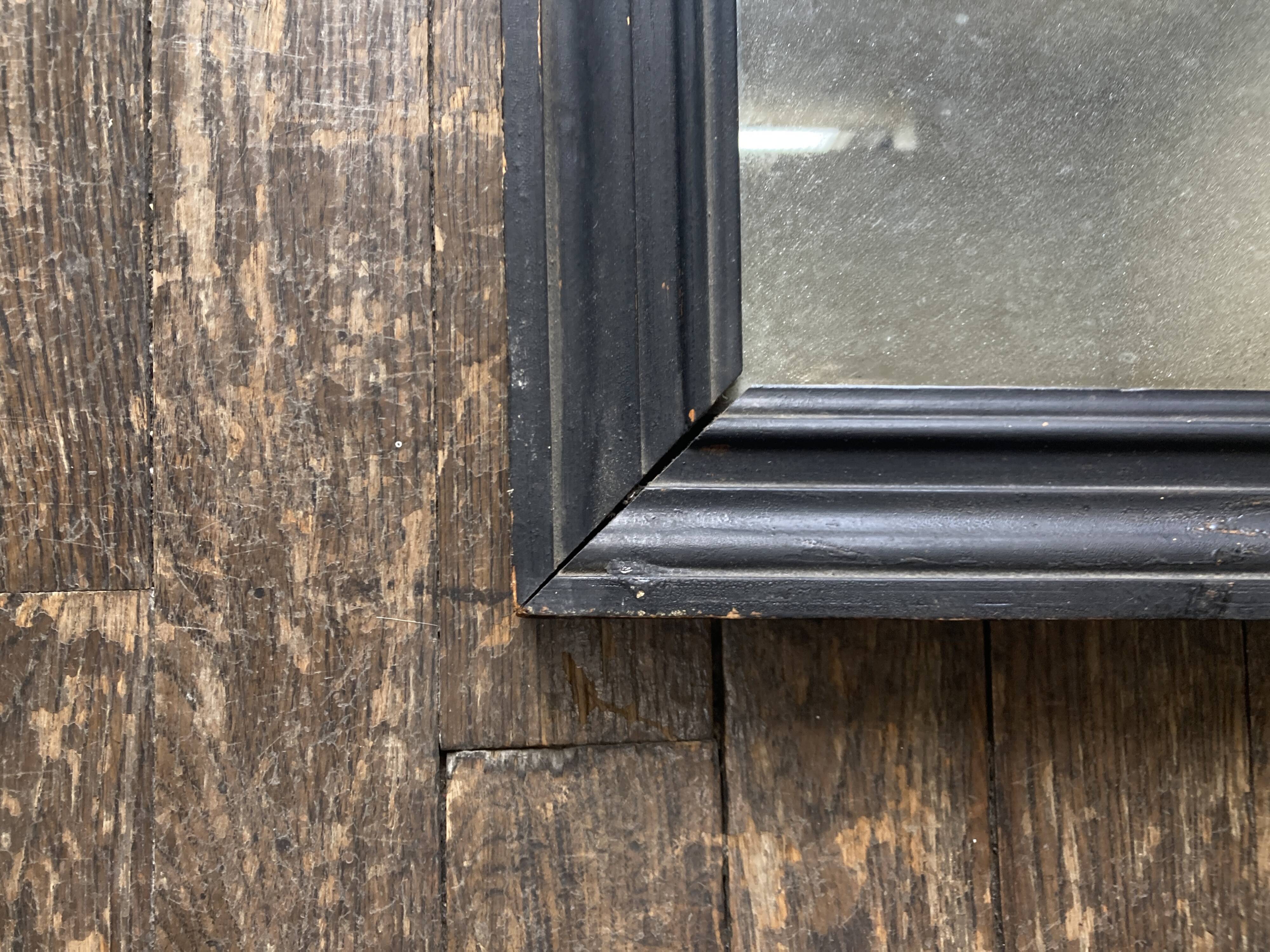 19th century blackened mirror with pitted glass 34cm x 40cm