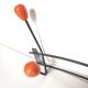 Black metal coat rack and orange wood balls