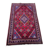 Authentic Persian carpet from Iran, hand-knotted in burgundy wool, 130x210cm.