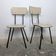 A pair of vintage Formica chairs with tapered legs from the 1960s.