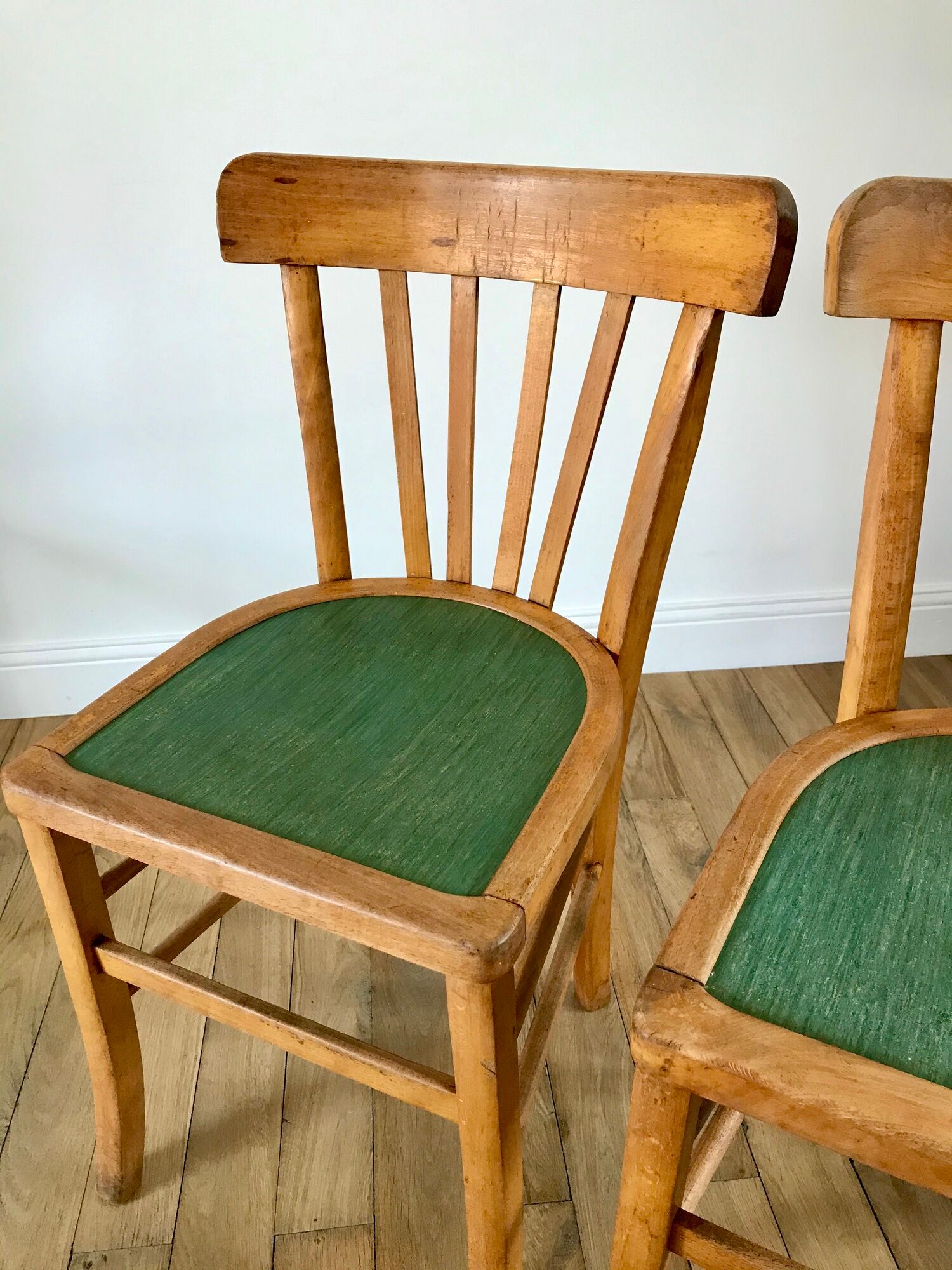 Pair of bistro chairs in light curved wood and green seat 1950s