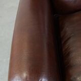 Comfortable and correct dark antique sheepskin English armchair in very good condition