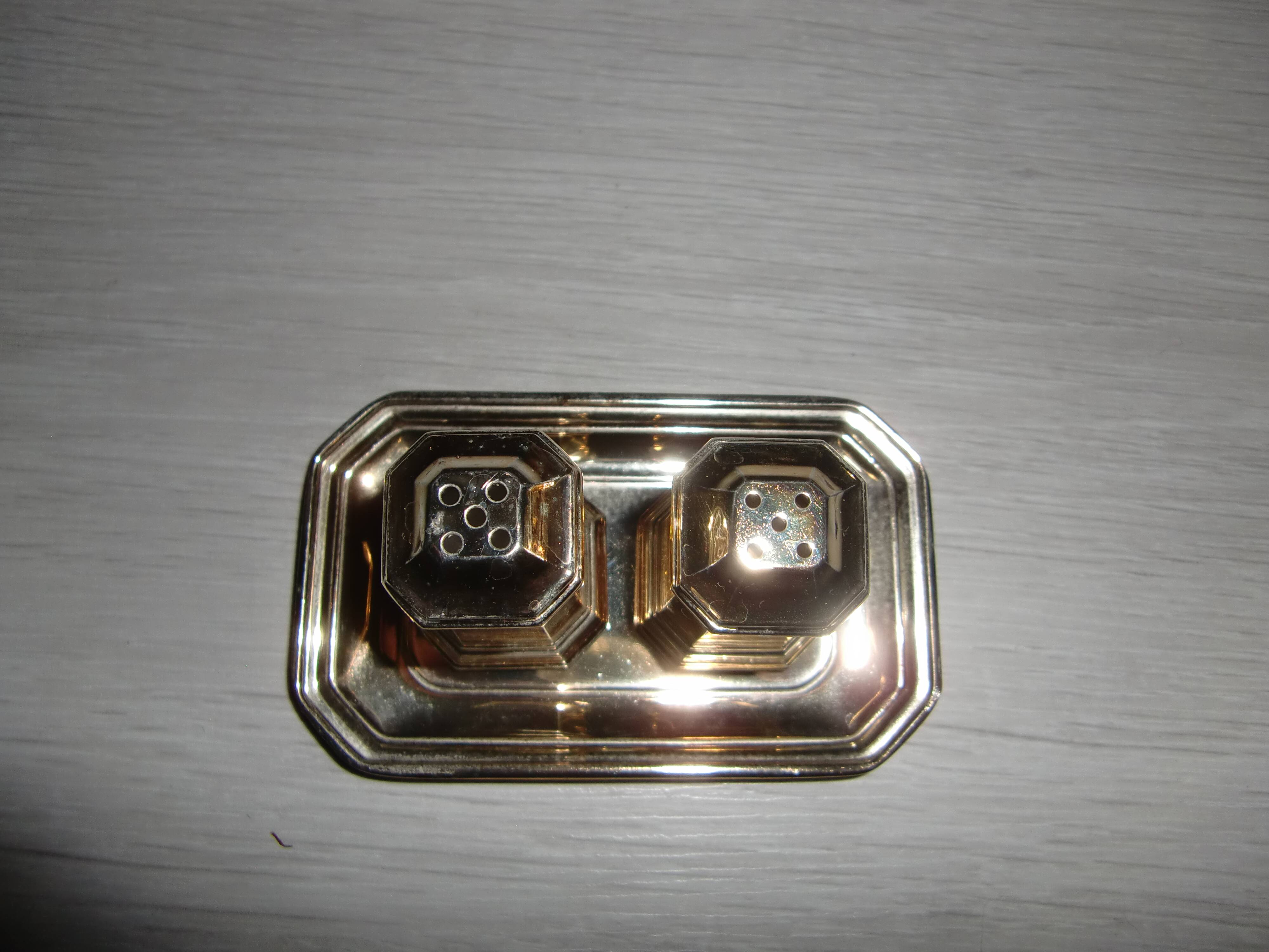 Silver-plated salt and pepper shakers presented on a small tray