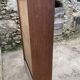Oak two-column filing cabinet with curtains.