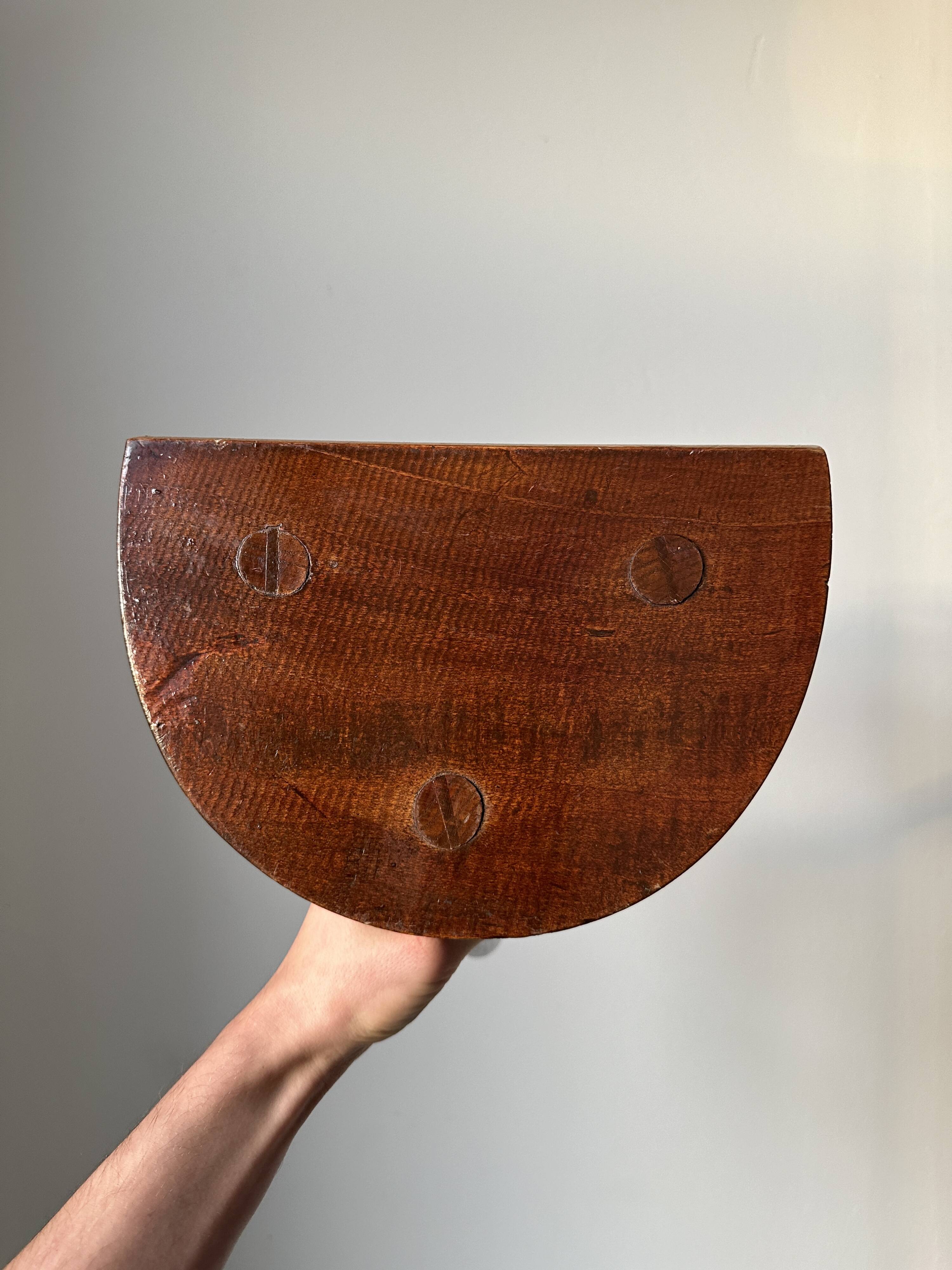 Varnished wooden stool with three legs