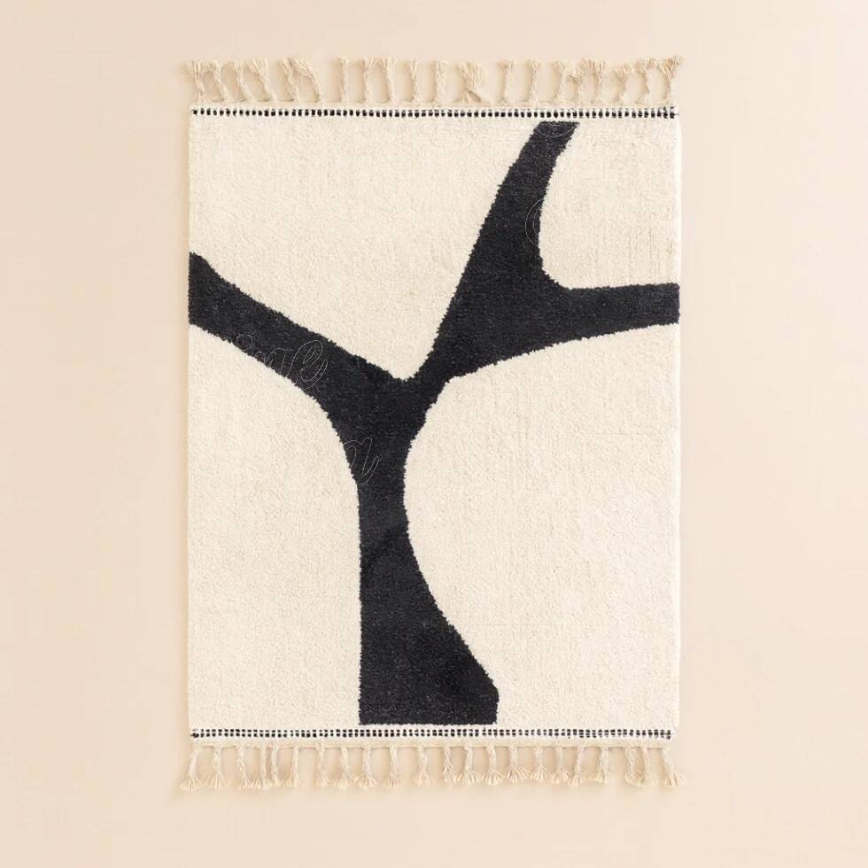 Atlas Berber rug in ecru with organic black pattern.
