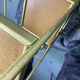 Small rolling trolley in brass and black plastic