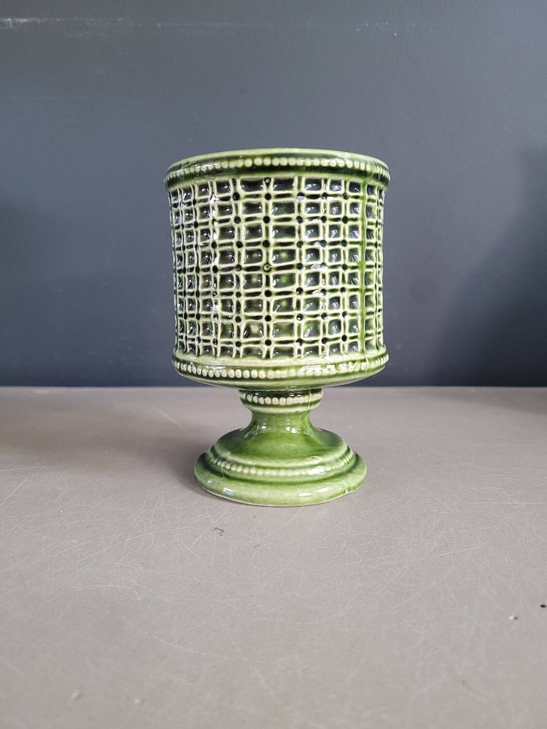 Green glazed ceramic flowerpot on stand