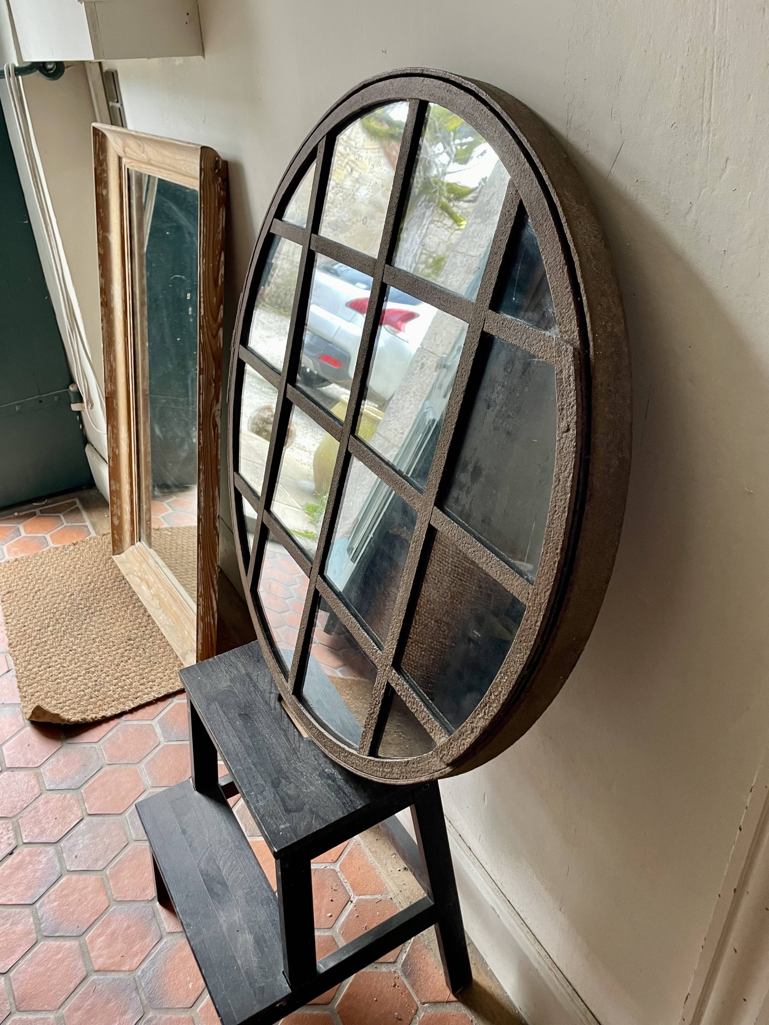 Round mirror mounted in mild steel