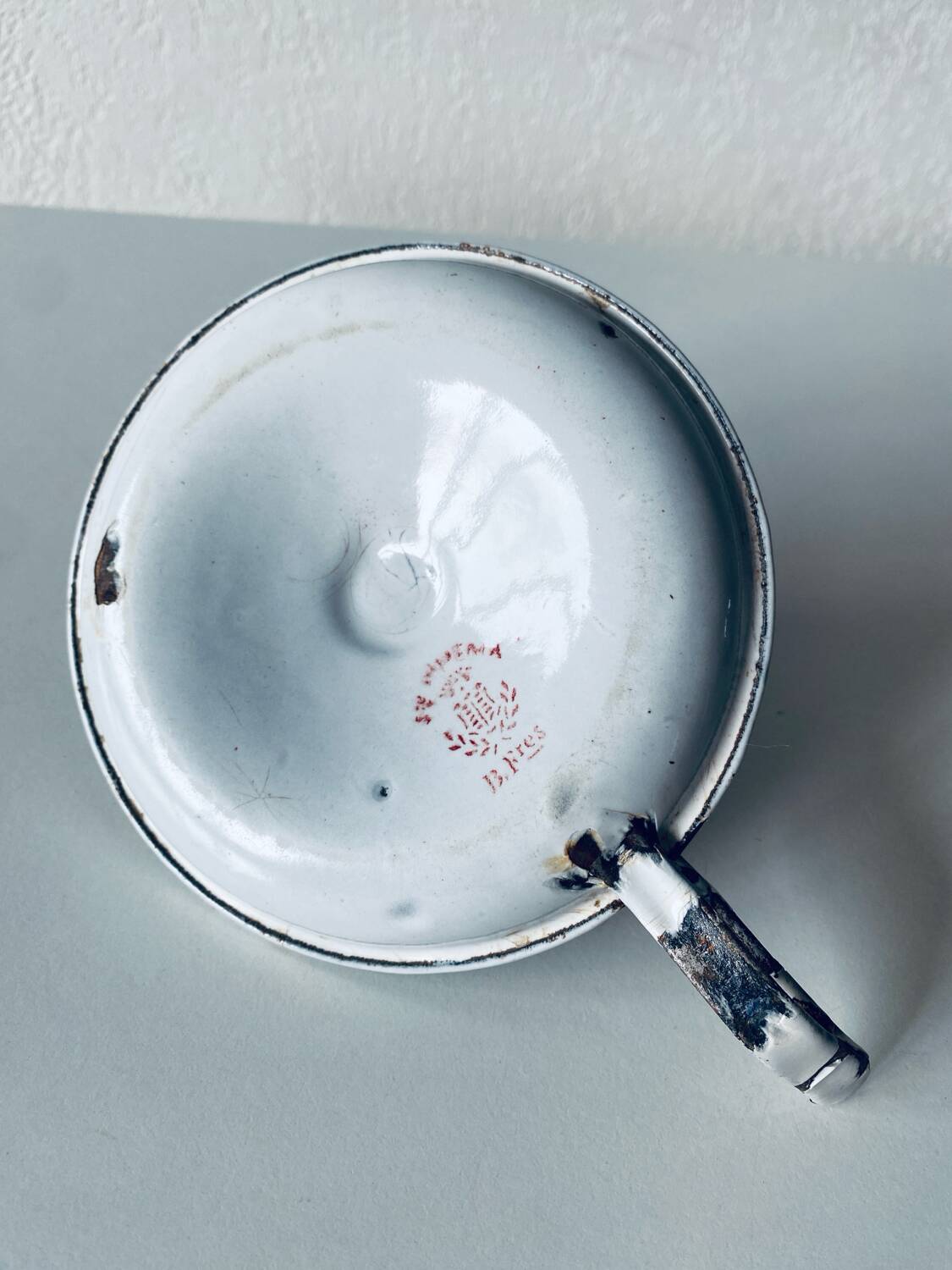 Antique enamelled metal candle holder