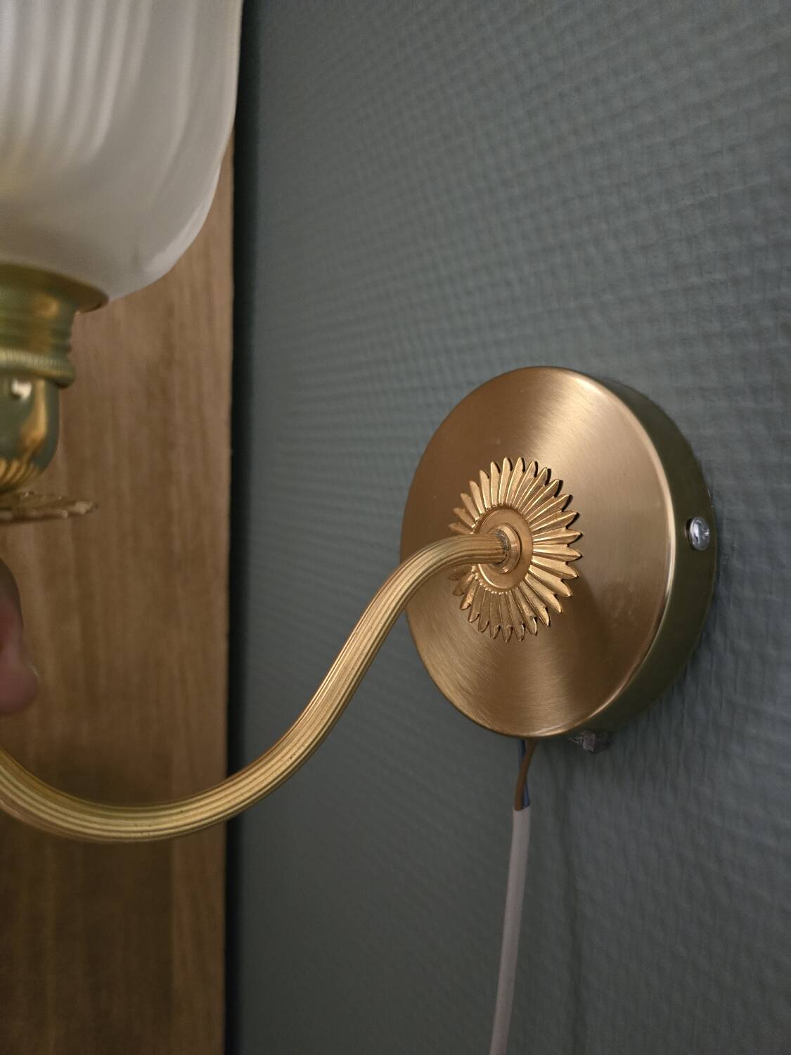 Frosted glass wall sconces and gilded brass in Art Deco style.