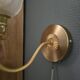 Frosted glass wall sconces and gilded brass in Art Deco style.
