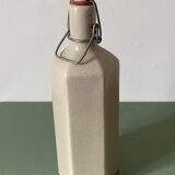 Faceted stoneware bottle signed La Cigogne, floral model (Diplotaxis muralis)