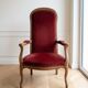 Louis XV style Voltaire armchair in wood and burgundy fabric.