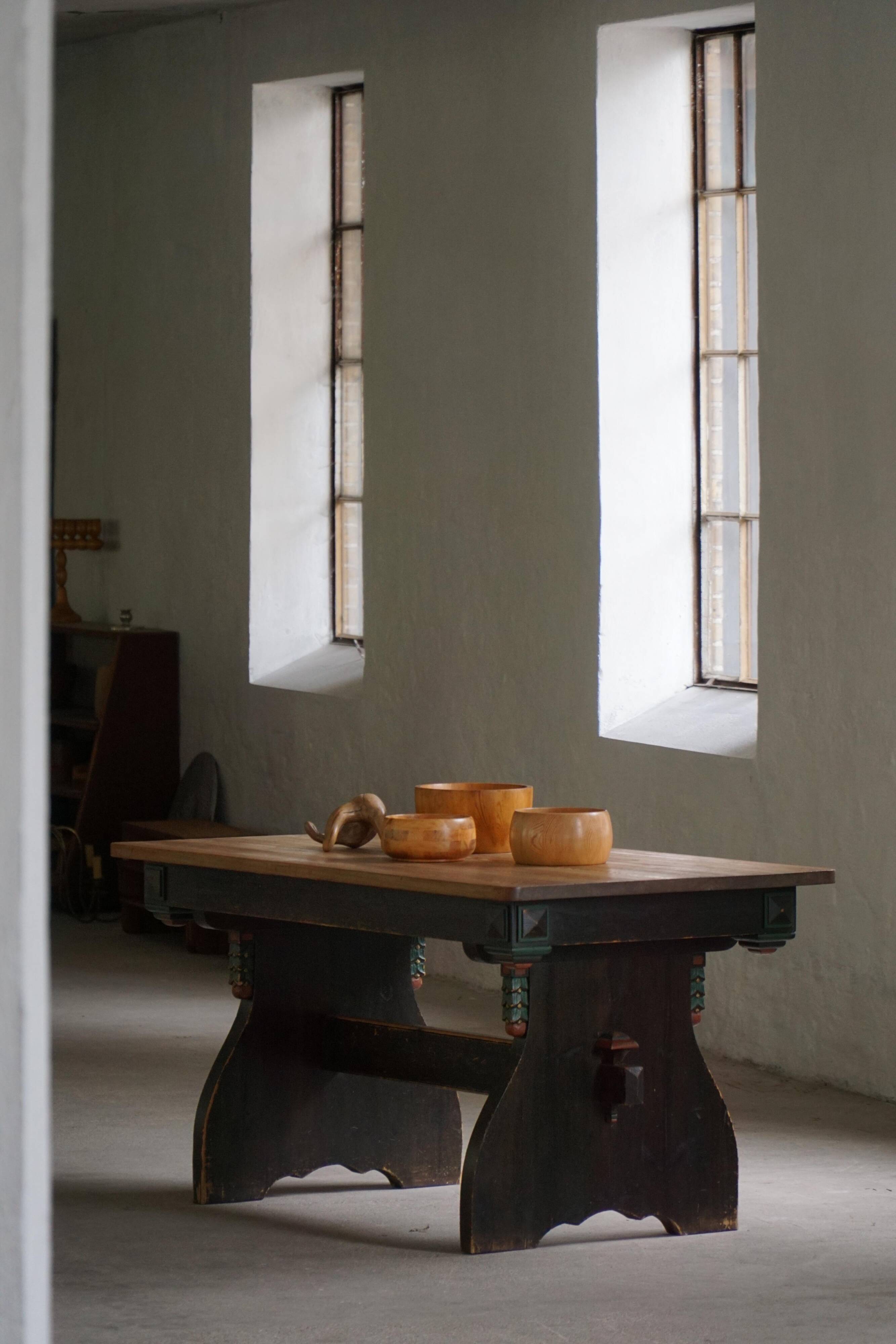 Rustic Scandinavian dining table in stained pine, Sweden, 1900-1940.