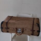 Old suitcase in canvas, wood and metal