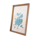 Decorative table with vintage blue flowers in a golden frame.