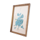 Decorative table with vintage blue flowers in a golden frame.