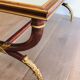 Coffee table in patinated and gilded carved wood with mirror top