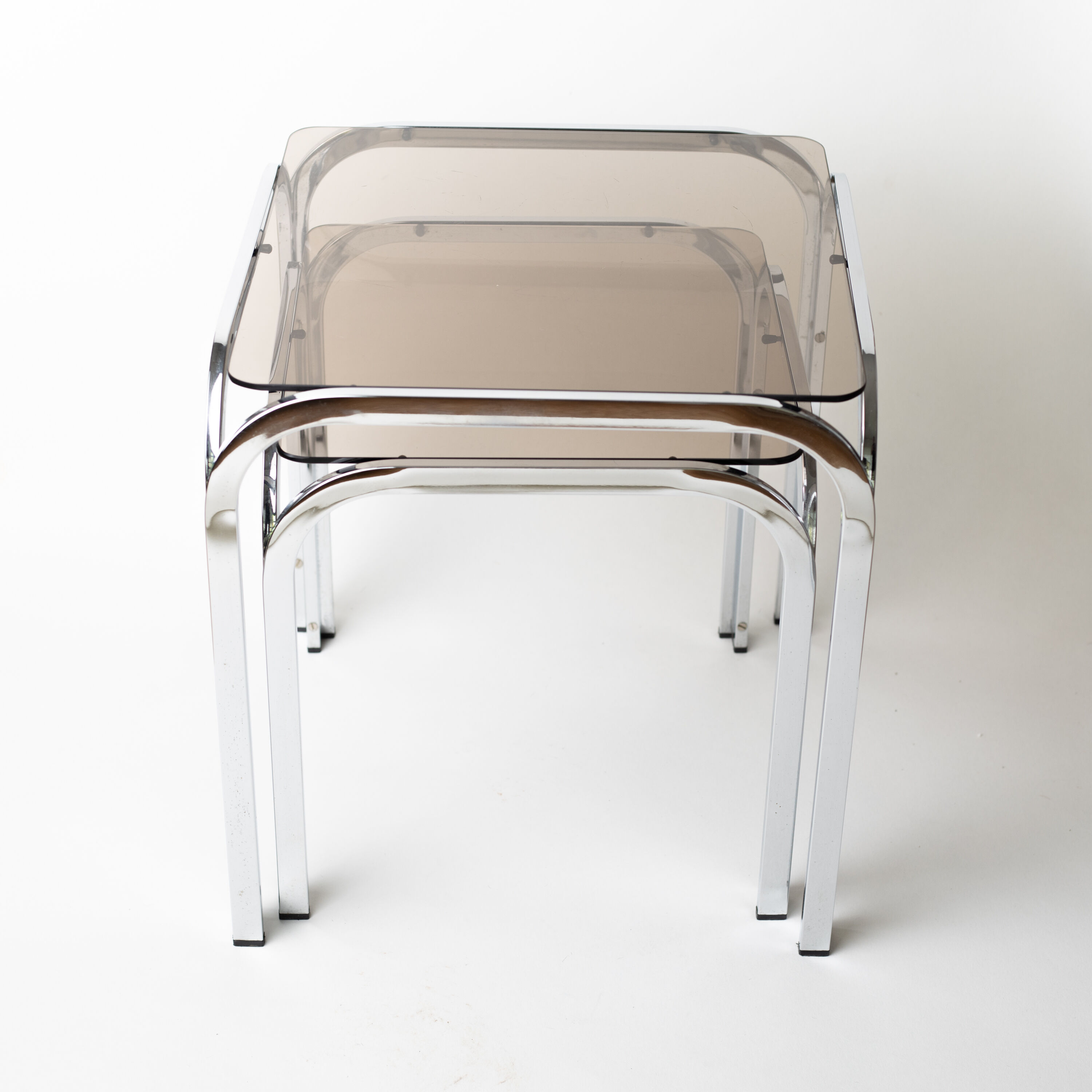 Pair of chrome nesting tables with smoked glass tops
