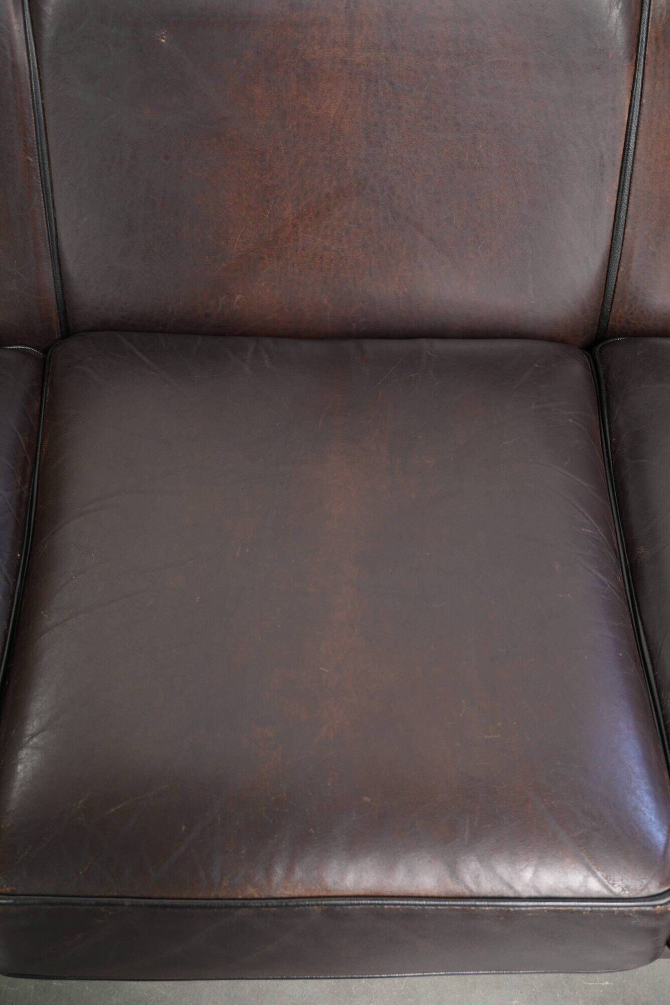 Set of a sheepskin sofa together with its matching club armchair