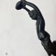 Antique cast iron coat hook with swimmer and shell basin.