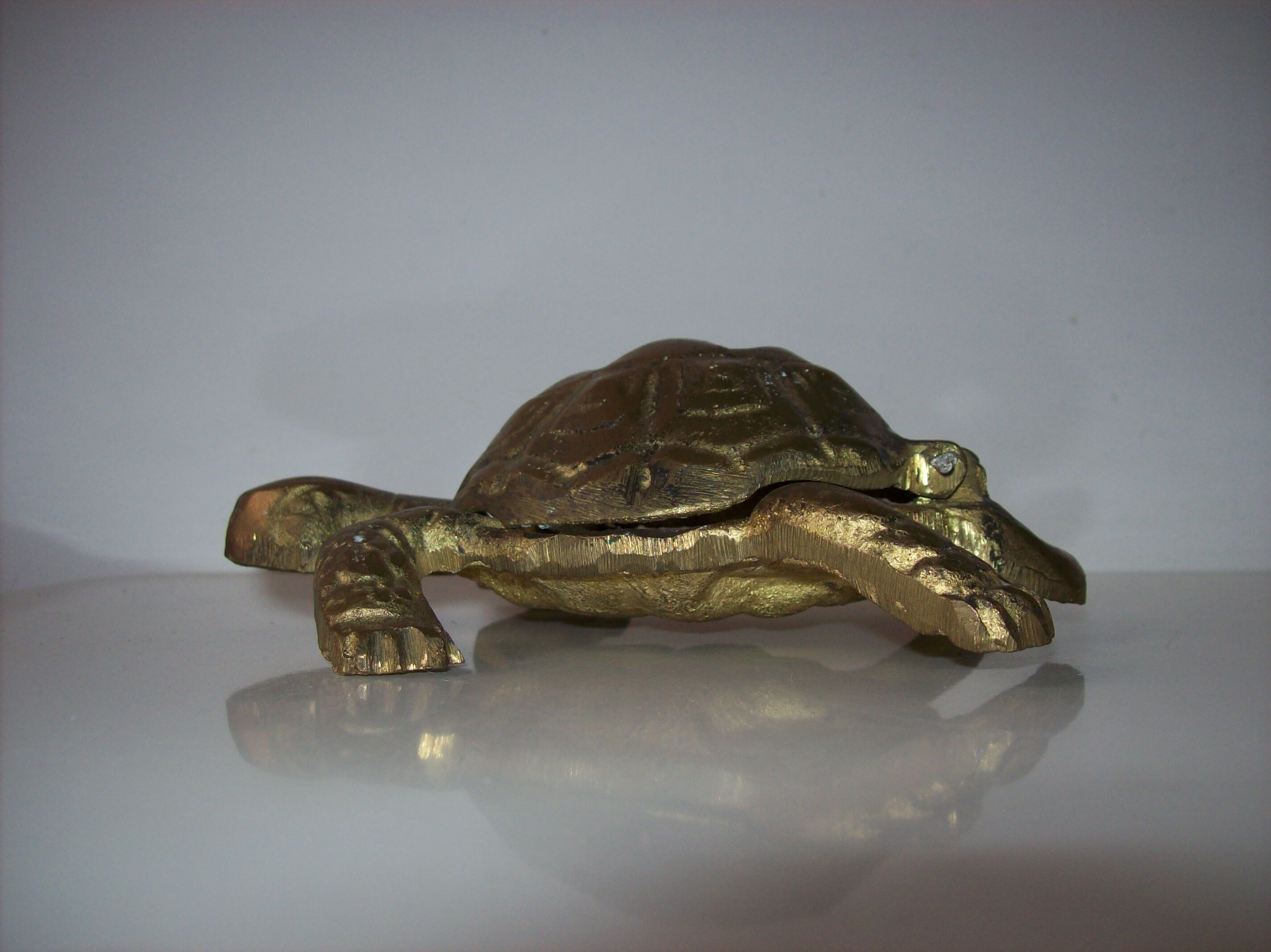 Golden brass ashtray has a turtle-shaped