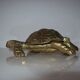 Golden brass ashtray has a turtle-shaped