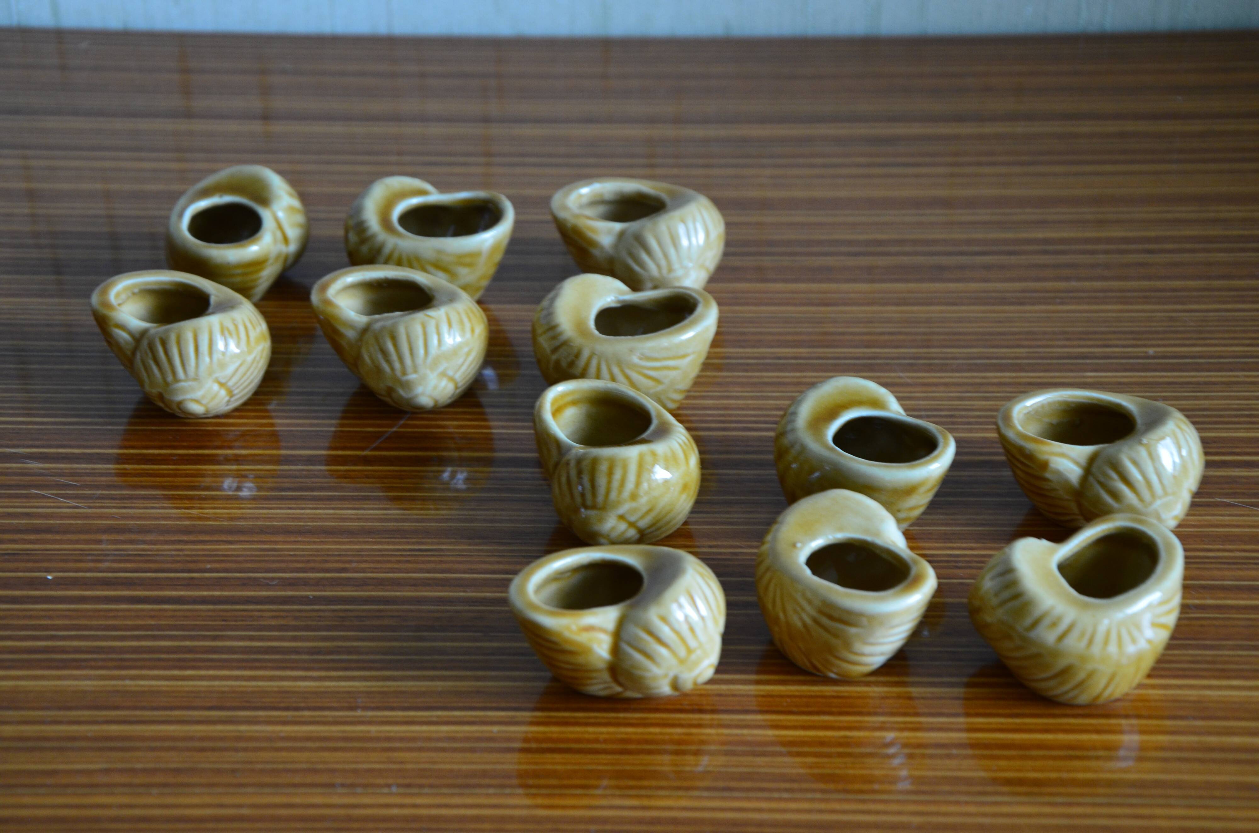 Lot of 12 enamelled sandstone snail shells
