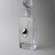 Vintage glass decanter from the 1980s, transparent glass with a silver plate and spherical stopper.