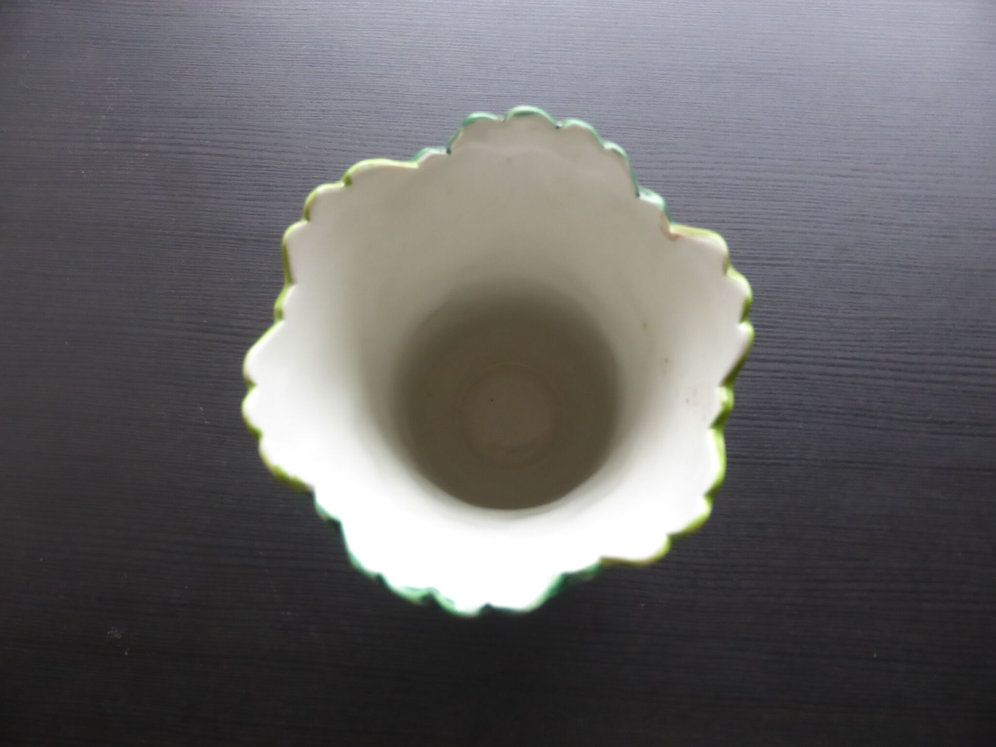 Ancient Asian ceramic vase green and white background decorated with butterflies