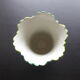 Ancient Asian ceramic vase green and white background decorated with butterflies