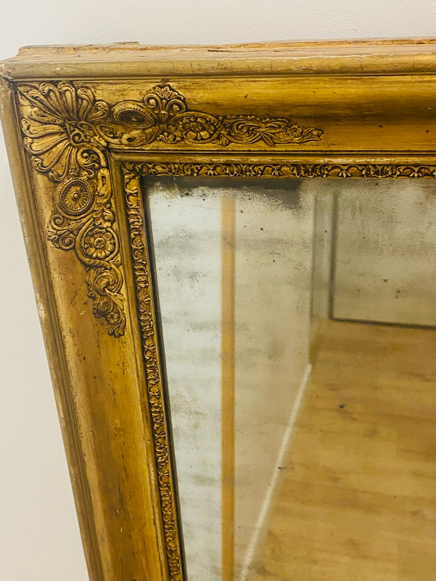 Antique mercury mirror with an Empire gold frame.