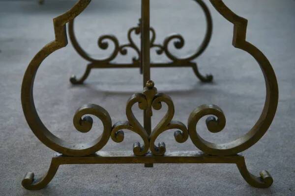 Side table with a gilt wrought iron base attributed to Gilbert Poillerat, with a travertine top, 1940s